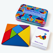 Colourful tangram puzzle pieces arranged next to illustrated activity cards and tin on a white background